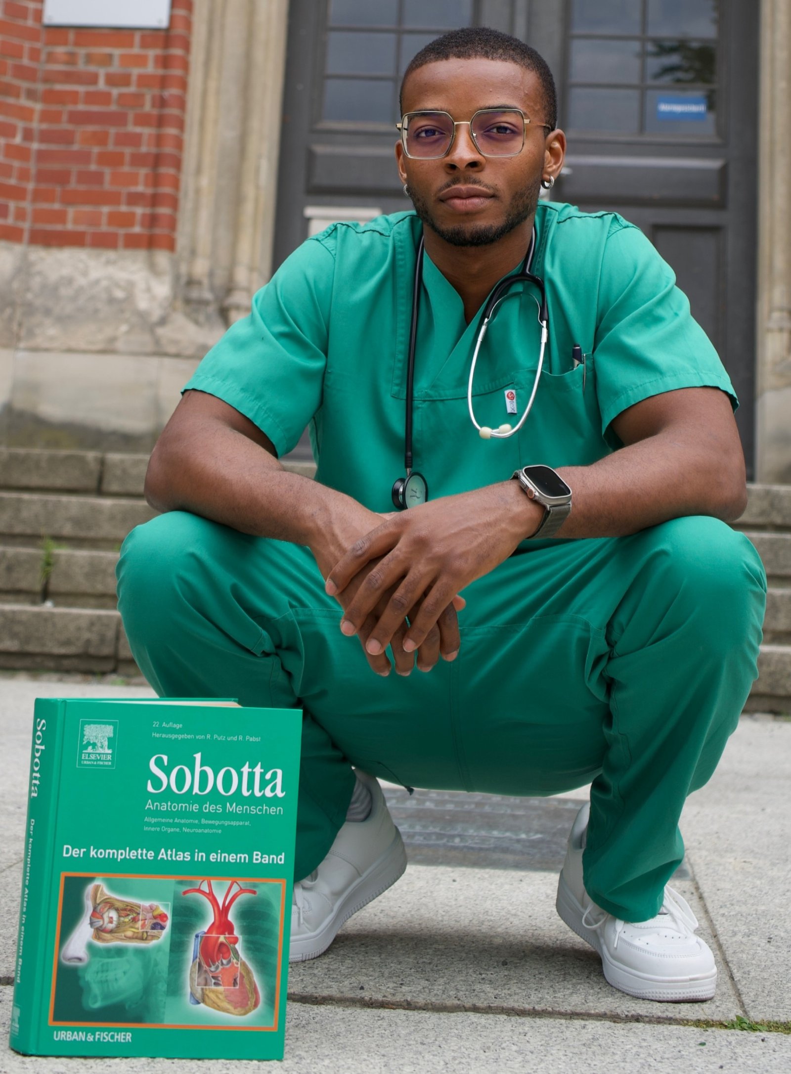 Dr Raymond Chinonso Edochie in medical scrubs